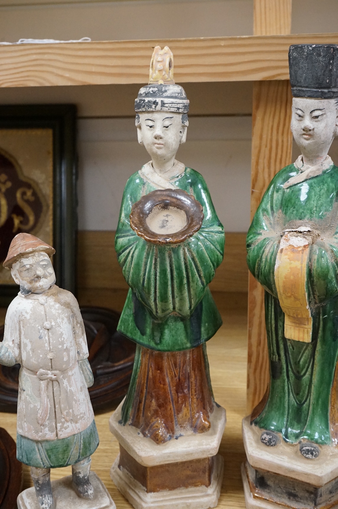 Three Chinese Ming sancai glazed figures of attendants, tallest figure 46cm